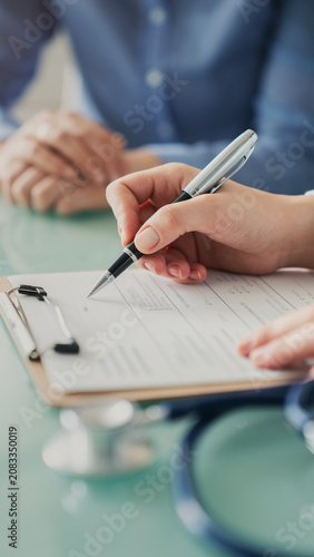 Doctor assisting patient with medical form