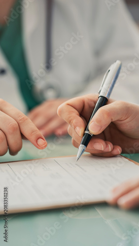 Doctor assisting patient with medical form