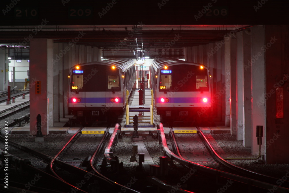 Fototapeta premium Taipei, Taiwan - July 3rd, 2026 - Two modern subway trains parked inside the maintenance depot.