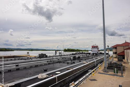 A barge with a load of oil passing through a lock and dam on the Mississippi River.