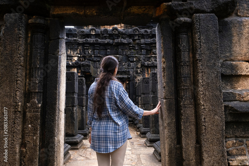 Female traveler exploring the ancient Nalanda Gedige temple in Sri Lanka. Historic stone architecture, Buddhist heritage, cultural tourism, and archaeological travel destination.