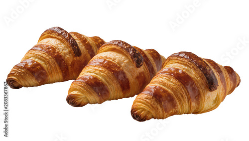 Tableau sur toile Three golden brown flaky croissants with layered pastry