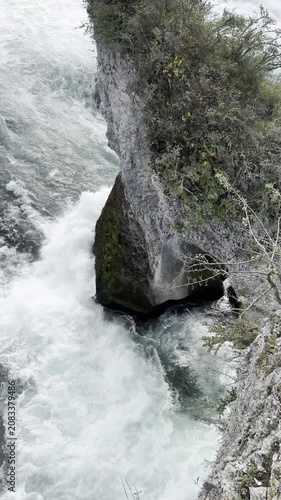 Schaffhausen, Switzerland - October 11, 2025: View of the Rhine Falls, Europe’s largest waterfall, with powerful cascades and the surrounding landscape on an autumn day.