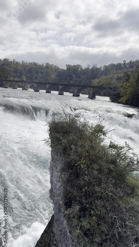Schaffhausen, Switzerland - October 11, 2025: View of the Rhine Falls, Europe’s largest waterfall, with powerful cascades and the surrounding landscape on an autumn day.
