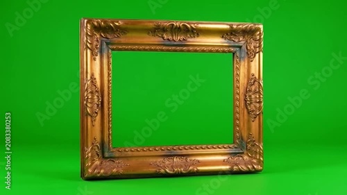 Ornate gold picture frame isolated on a green screen background