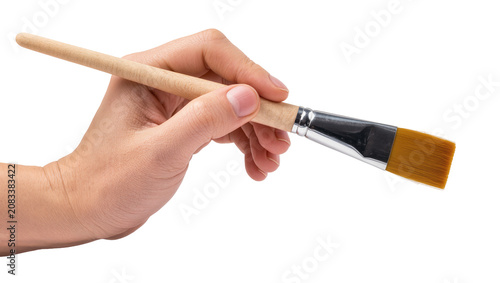 Billede på lærred Hand holding flat paintbrush with wooden handle and metal ferrule