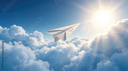 A white paper airplane flies through a bright blue sky filled with fluffy white clouds. The sun shines intensely, creating a radiant glow and sunbeams.