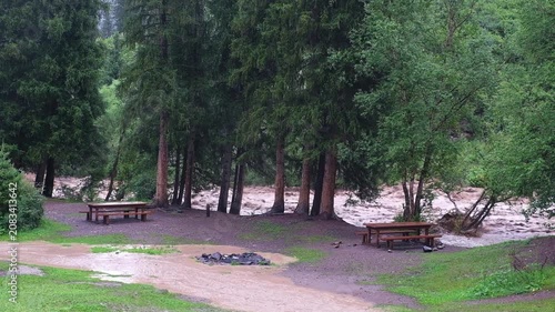Mudflow hazard and flooding of a recreation camp site near the Turgen River in Turgen Gorge, Almaty region, Kazakhstan. Suitable for news, environmental safety, and natural disaster backgrounds.