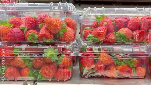 Shelf with Various Packaged Berries – Strawberries, Blueberries, and Raspberries in Plastic Containers in a Supermarket
