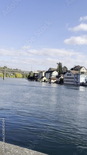 Schaffhausen, Switzerland – October 11, 2025: Sunny views of the Rhine River flowing through the historic city, with recognizable buildings and riverside architecture along the waterfront.