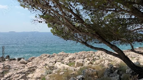Exploring rocky shores and clear blue waters along the Croatian coast on a sunny day in summer