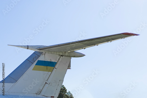 Quadro su tela Tail Fin of Cargo Plane with Ukrainian Flag Against Blue Sky