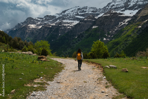 A young girl hiking alone in the Pyrenees, Pineta Valley, Monte Perdido, Camino de los Llanos de la Larri, Aragón, Huesca, Spain