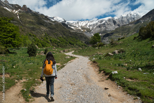 A young girl hiking alone in the Pyrenees, Pineta Valley, Monte Perdido, Camino de los Llanos de la Larri, Aragón, Huesca, Spain