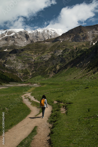 A young girl hiking alone in the Pyrenees, Pineta Valley, Monte Perdido, Camino de los Llanos de la Larri, Aragón, Huesca, Spain