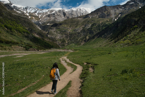 A young girl hiking alone in the Pyrenees, Pineta Valley, Monte Perdido, Camino de los Llanos de la Larri, Aragón, Huesca, Spain