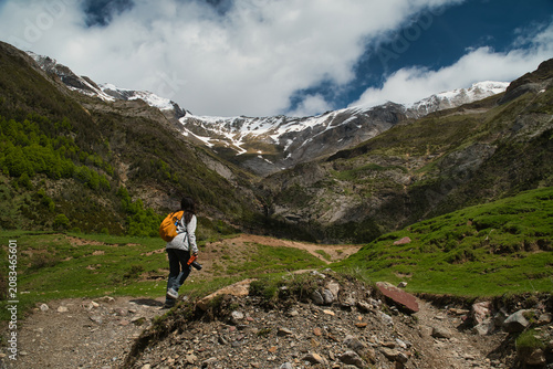 A young girl hiking alone in the Pyrenees, Pineta Valley, Monte Perdido, Camino de los Llanos de la Larri, Aragón, Huesca, Spain