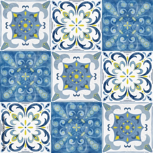Decorative ceramic tiles featuring intricate blue and white patterns with floral and geometric designs arranged in a square layout on a textured surface