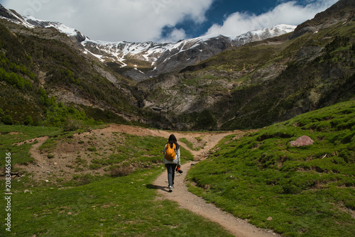 A young girl hiking alone in the Pyrenees, Pineta Valley, Monte Perdido, Camino de los Llanos de la Larri, Aragón, Huesca, Spain
