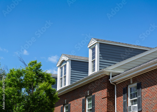 Gable dormer windows on a brick residential building in Charlestown, Boston
