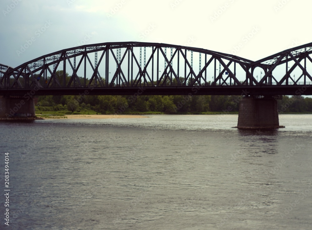 Fototapeta premium Steel truss arch bridge over a wide river