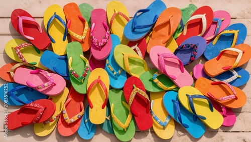 Assorted Flip-Flops Scattered on Wooden Surface