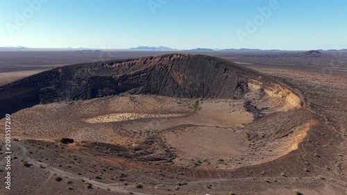 Drone dronie footage revealing the massive El Colorado volcanic crater inside El Pinacate and Gran Desierto de Altar Biosphere Reserve in Sonora, Mexico. The aerial view showcases the dramatic volcani