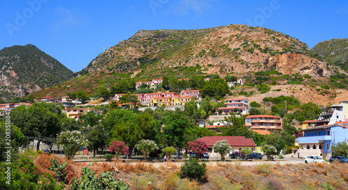 Quadro su tela View of colorful residential buildings nestled against the hillside in the town
