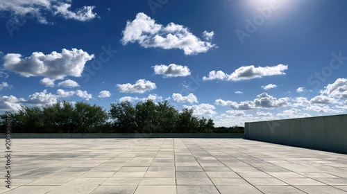 Vast paved plaza under bright sun with fluffy clouds and green trees