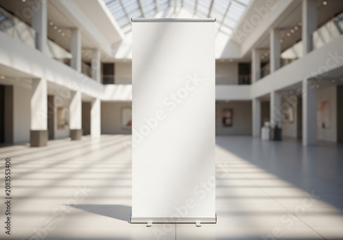 Blank roll up banner stand in bright modern hall interior mockup