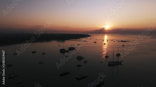 Bali Coastline at Sunrise with Numerous Boats and Calm Ocean - Drone View