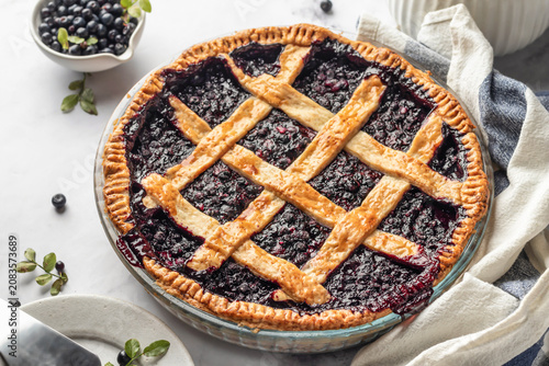 Photos Blueberry pie with lattice crust on white marble table, traditional homemade des
