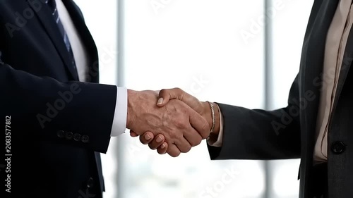 Professional business handshake in modern office environment representing high quality 4k stock video of successful corporate deal