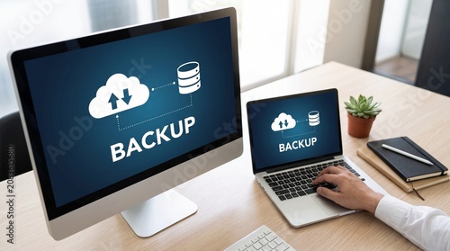 Desktop Monitor and Laptop Displaying Cloud Backup Data in Modern Office