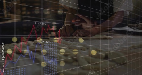 Vertical image: Baker pressing dough, grid fading in animating charts over hands showing sales