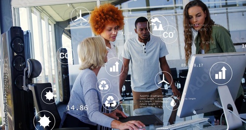 Seated lead manipulating mouse, team reviewing environment data with floating CO2 charts on monitor