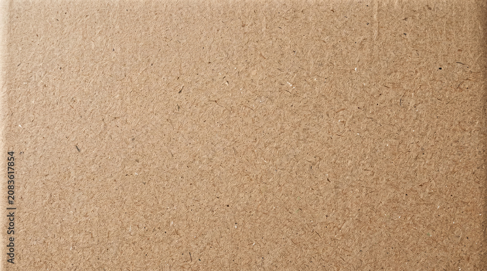 Fototapeta premium Textured brown cardboard surface close‑up