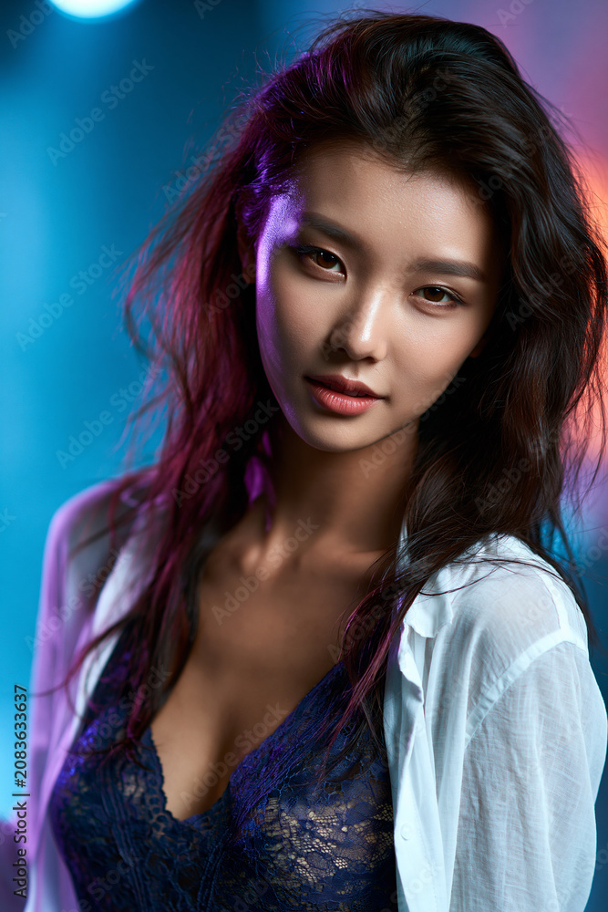 Fototapeta premium beautiful korean fashion model with vibrant pastel background, flawless korean beauty portrait with elegant styling, confident asian model in colorful studio portrait