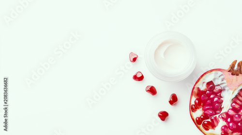 Pomegranate Seeds and Moisturizing Cream Jar for Skincare and Superfood Concept, Isolated on White