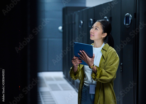 Female IT Professional Reviewing Infrastructure on Tablet