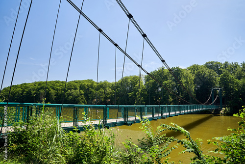 Pedestrian and cyclist suspension bridge over Lake Radun in Walcz