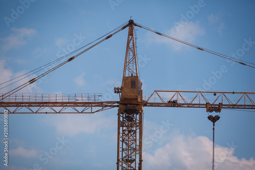 Konstfotografi Close-up of a yellow tower crane jib end against clear blue sky with large copy