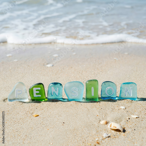 Pension Word Spelled with Sea Glass Stones on Sandy Beach