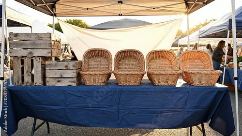 Static Wide Shot of An Empty Farmers Market Stall During Early Morning Setup With Wooden Baskets and Blue Table