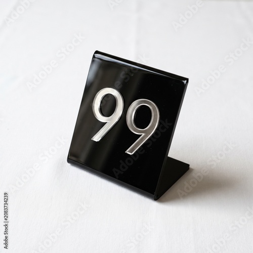 Modern black table number 99 display for event and restaurant settings
