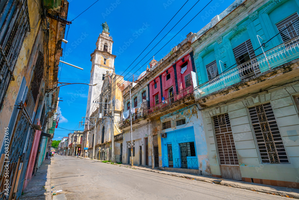 Fototapeta premium Historic colonial street with church tower in Havana, Cuba