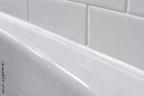 A smooth, continuous bead of white sealant along a bathtub and tile joint.