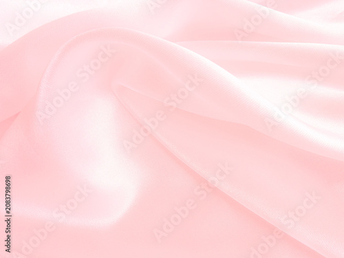 Pink wrinkled fabric background. Close up Satin cloth texture