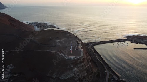 Aerial drone view of the Morro de Arica and coastline during sunset in Chile