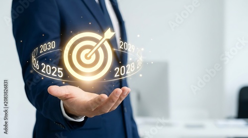 Businessman holding a glowing target with future years for long term business planning and strategic success